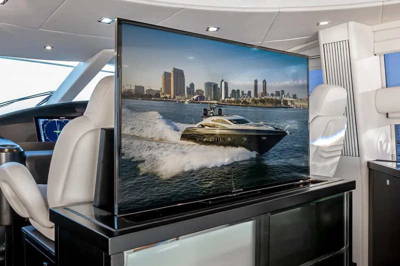 Norma Jean Yacht Photos Pics Luxurious interior of 2007 Sunseeker Predator 82 yacht with cityscape view on TV.