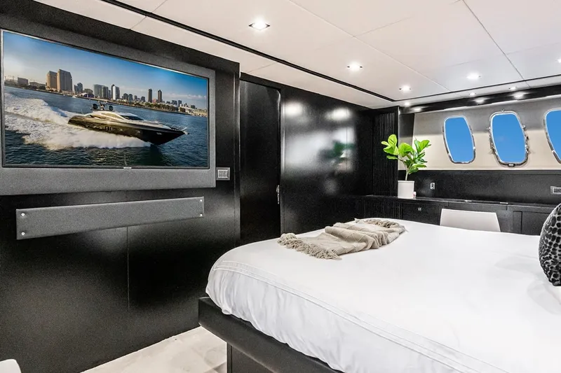 Norma Jean Yacht Photos Pics Luxurious bedroom interior of 2007 Sunseeker Predator 82 yacht with modern decor and porthole windows.