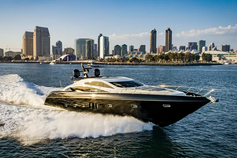 Norma Jean Yacht Photos Pics Luxurious 2007 Sunseeker Predator 82 yacht cruising near city skyline.