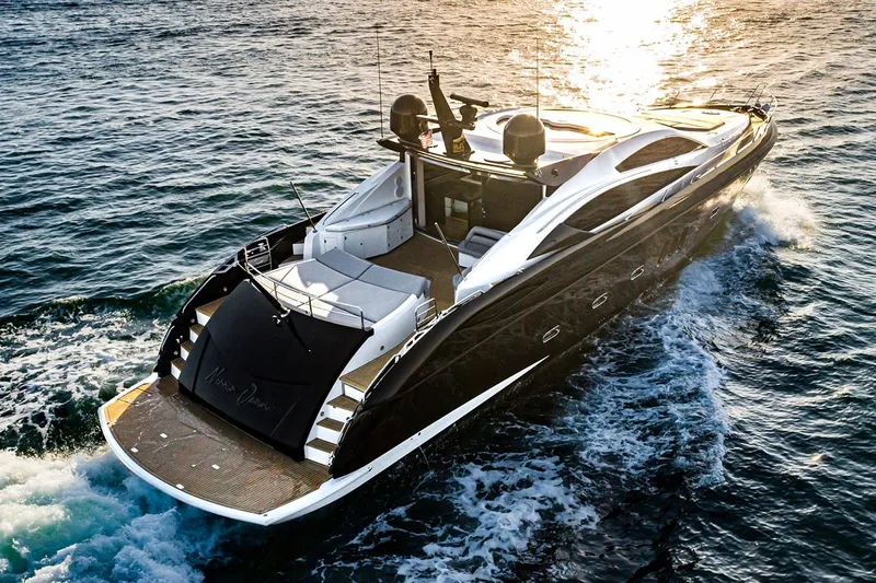 Norma Jean Yacht Photos Pics Luxury 2007 Sunseeker Predator 82 yacht cruising on open water at sunset.