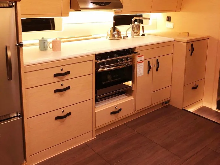 Caretta2 Yacht Photos Pics Modern kitchen in 2018 Jeanneau 54 yacht with sleek cabinetry and stainless steel appliances.