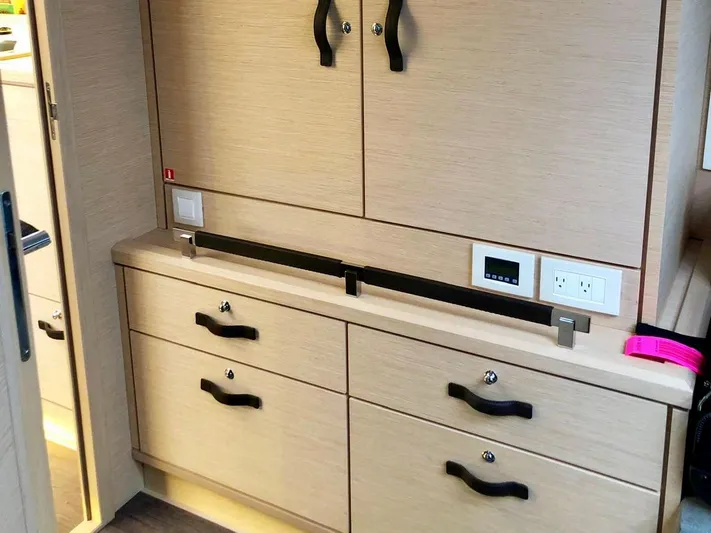 Caretta2 Yacht Photos Pics Interior cabinetry of a 2018 Jeanneau 54 yacht, featuring modern wood finish and sleek handles.