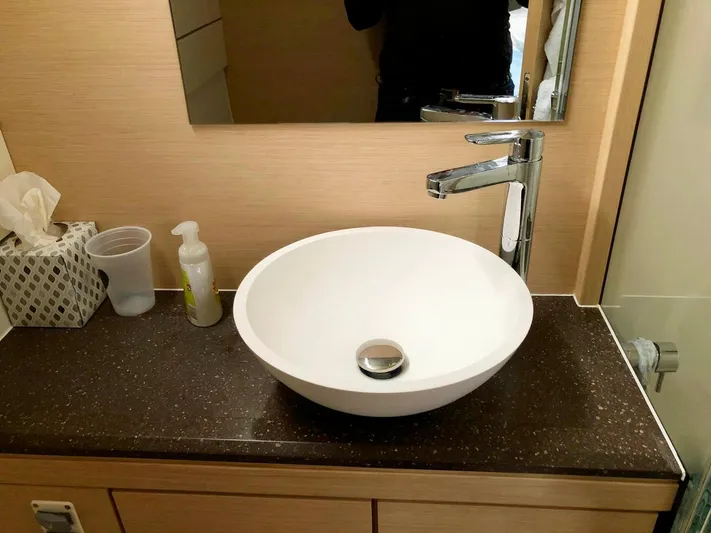 Caretta2 Yacht Photos Pics Modern bathroom sink on Jeanneau 54 yacht, 2018 model, with sleek faucet and countertop.