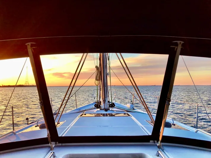 Caretta2 Yacht Photos Pics Jeanneau 54 sailboat at sunset, 2018 model, ocean view from deck.