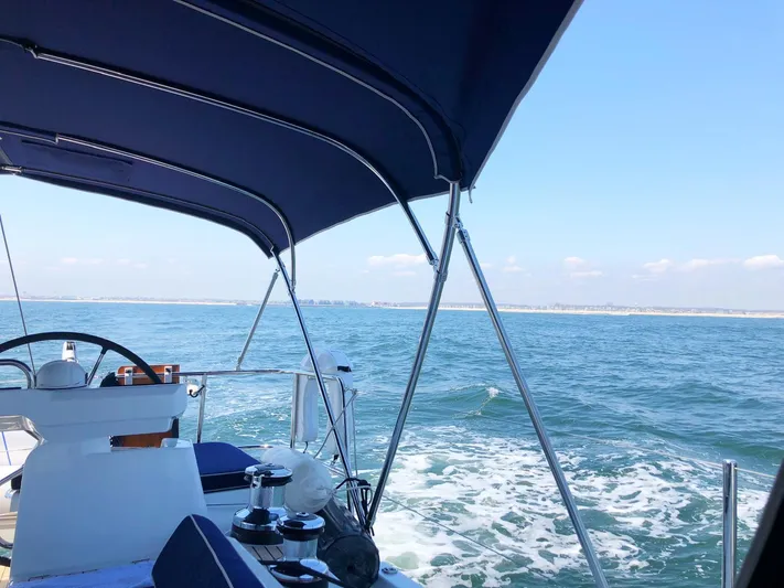 Caretta2 Yacht Photos Pics 2018 Jeanneau 54 yacht sailing on open sea under clear blue sky.