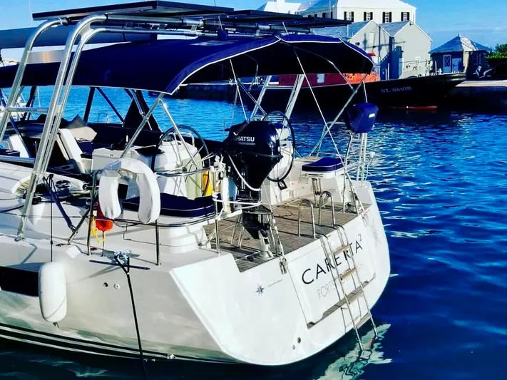 Caretta2 Yacht Photos Pics 2018 Jeanneau 54 yacht docked in a sunny marina, featuring a sleek design and modern amenities.