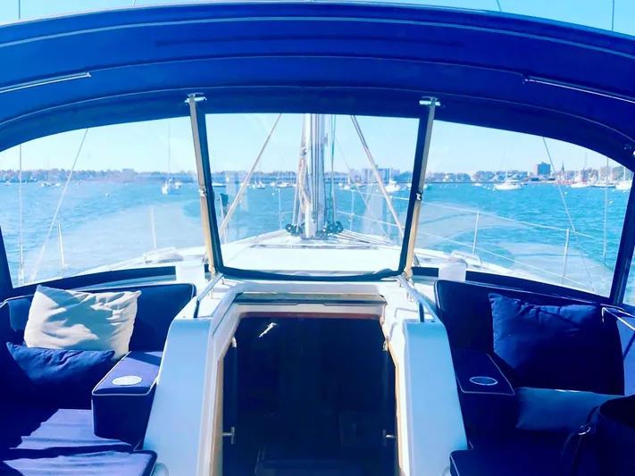 Caretta2 Yacht Photos Pics 2018 Jeanneau 54 yacht interior with blue cushions, overlooking calm waters.