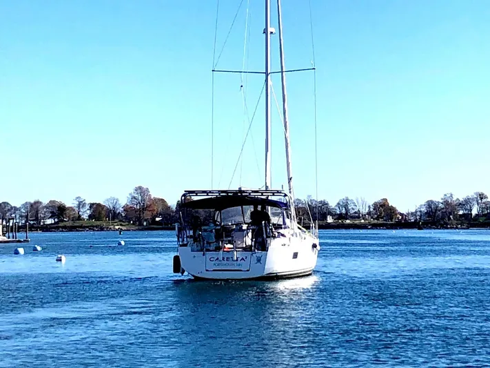 Caretta2 Yacht Photos Pics 2018 Jeanneau 54 sailboat on calm water under clear blue sky.