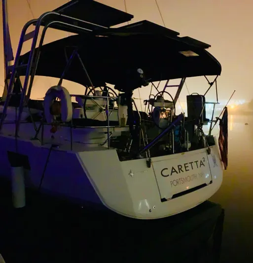 Caretta2 Yacht Photos Pics Jeanneau 54 sailboat, 2018 model, docked at night with visible name "Caretta".