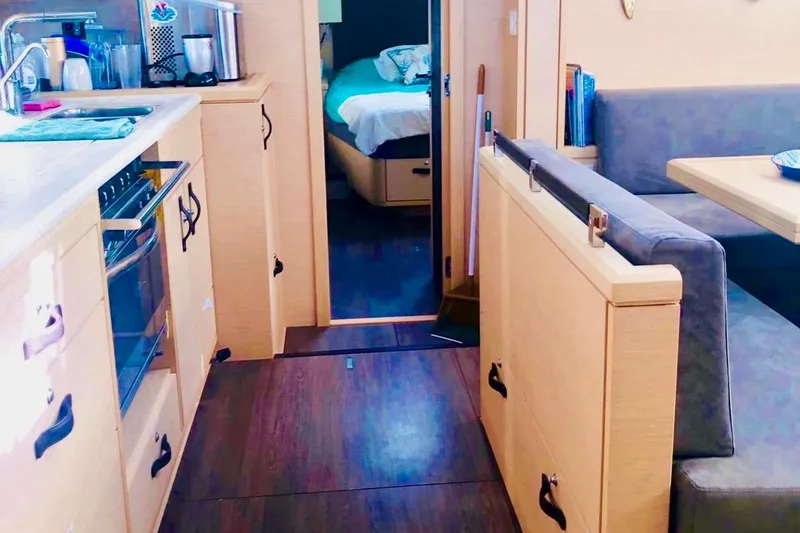 Caretta2 Yacht Photos Pics Interior of 2018 Jeanneau 54 yacht with kitchen and dining area.