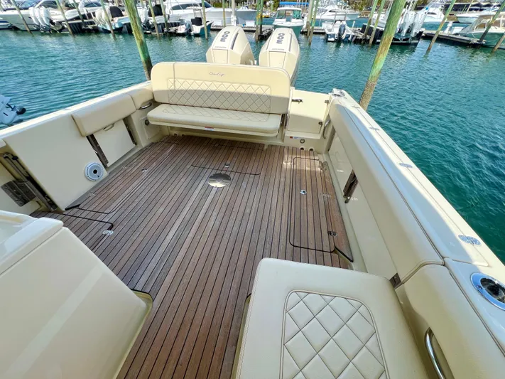  Yacht Photos Pics 2022 Chris-Craft Calypso 30 boat with teak deck and cushioned seating in marina.