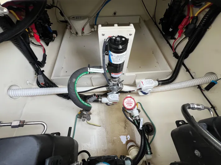  Yacht Photos Pics Engine compartment of 2022 Chris-Craft Calypso 30 with visible hoses and wiring.