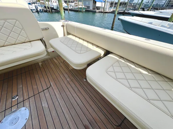  Yacht Photos Pics 2022 Chris-Craft Calypso 30 boat interior with beige seating and wooden deck.