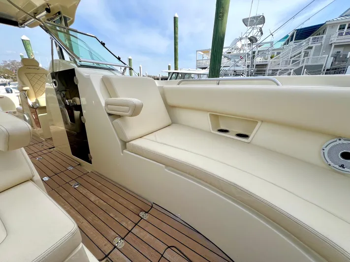  Yacht Photos Pics 2022 Chris-Craft Calypso 30 interior with beige seating and wooden deck.