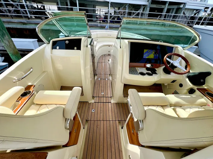  Yacht Photos Pics 2022 Chris-Craft Calypso 30 boat interior with luxurious seating and wooden accents.