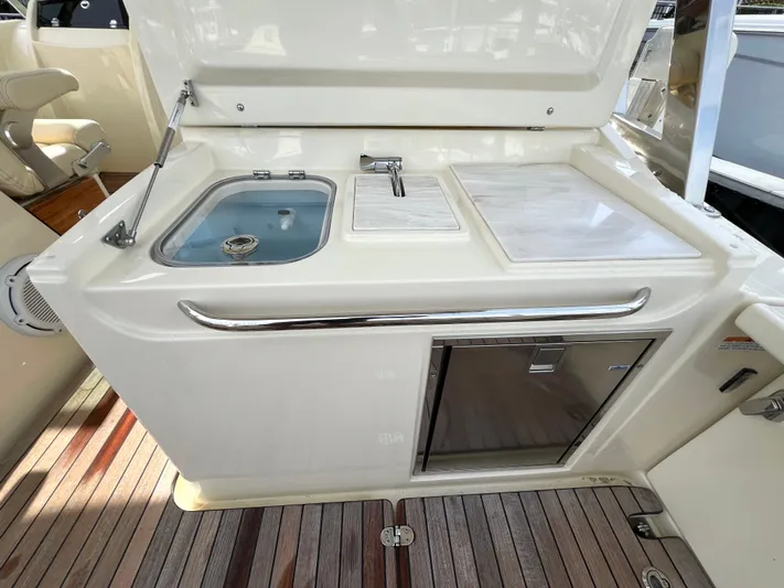  Yacht Photos Pics 2022 Chris-Craft Calypso 30 boat kitchenette with sink, faucet, and storage.