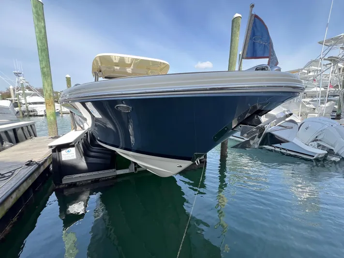  Yacht Photos Pics 2022 Chris-Craft Calypso 30 boat docked in marina, blue hull, sunny day.