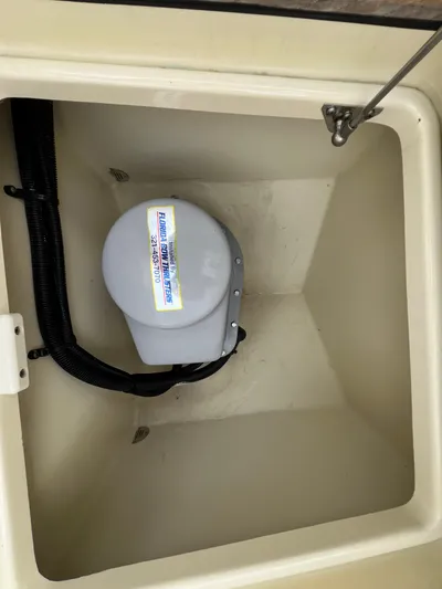  Yacht Photos Pics Storage compartment in a 2022 Chris-Craft Calypso 30 boat, featuring a mounted device.