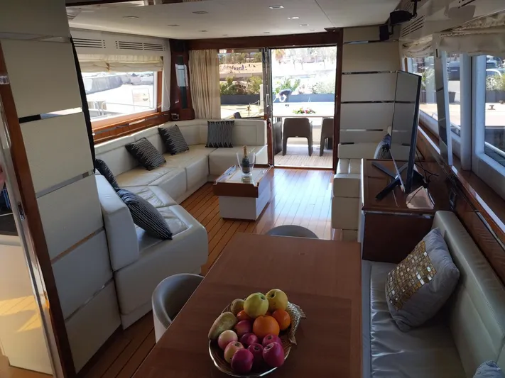  Yacht Photos Pics Luxurious interior of Leonard 66 yacht, featuring elegant seating and a fruit bowl centerpiece.