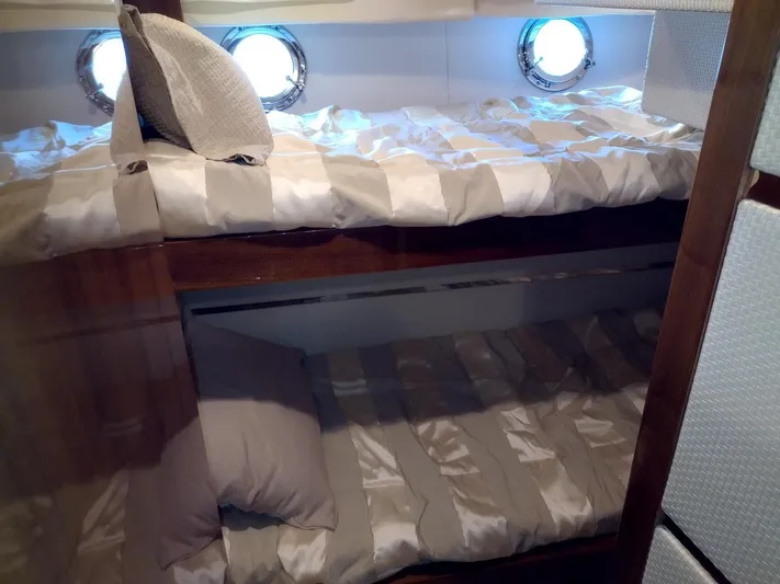  Yacht Photos Pics Bunk beds in a 2009 Leonard 66 yacht cabin with porthole windows.
