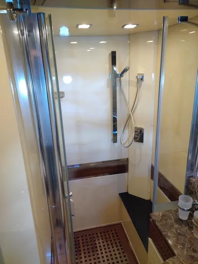  Yacht Photos Pics Luxurious shower in 2009 Leonard 66 yacht with modern fixtures and wooden accents.