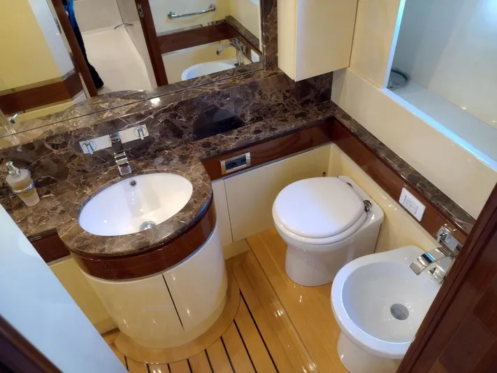  Yacht Photos Pics Luxurious yacht bathroom with marble countertop, modern fixtures, and wooden flooring in Leonard 66, 2009.