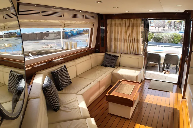  Yacht Photos Pics Luxurious interior of 2009 Leonard 66 yacht with cream leather seating and wooden flooring.