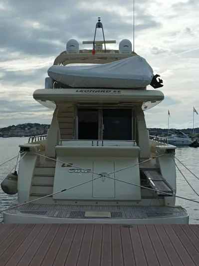  Yacht Photos Pics Luxury yacht Leonard 66, 2009 model, docked at marina under cloudy sky.