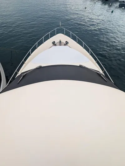  Yacht Photos Pics Bow view of 2009 Leonard 66 yacht on calm water.