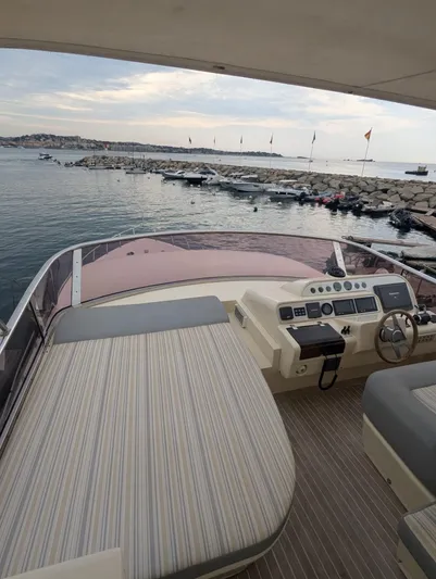  Yacht Photos Pics Luxury Leonard 66 yacht interior, 2009 model, overlooking serene marina and rocky shoreline.