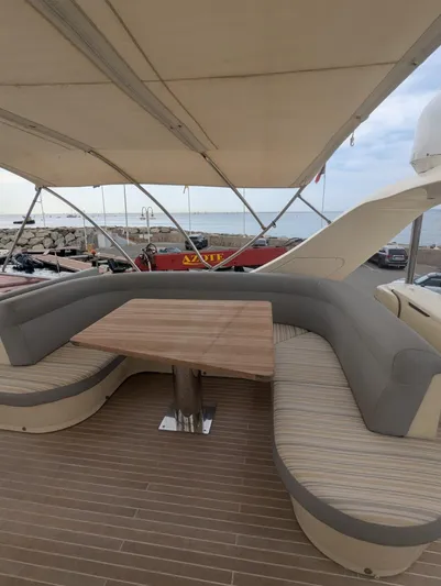  Yacht Photos Pics Luxury yacht Leonard 66 (2009) with elegant outdoor seating and wooden table.
