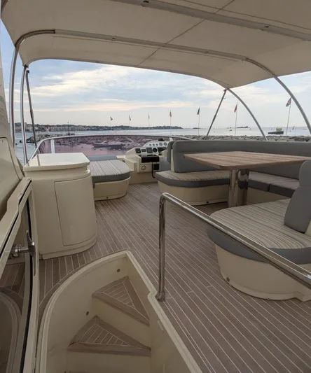  Yacht Photos Pics Luxurious Leonard 66 yacht interior with elegant seating, 2009 model, overlooking serene waters.