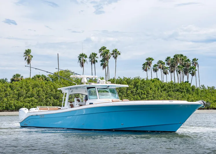  Yacht Photos Pics 2020 HCB Suenos boat cruising on water with palm trees in the background.