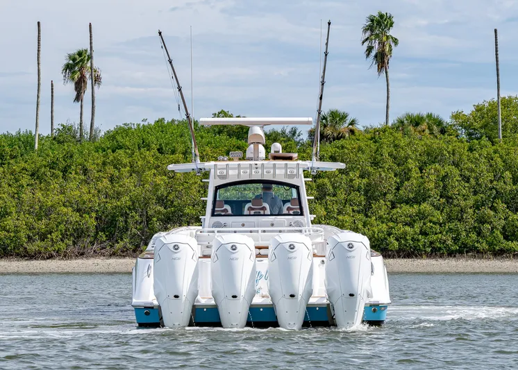  Yacht Photos Pics 2020 HCB Suenos boat with multiple engines cruising near lush greenery and palm trees.
