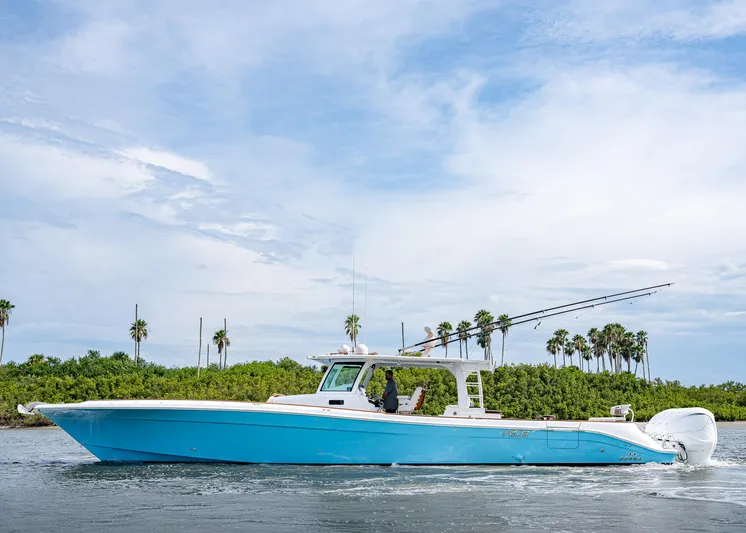  Yacht Photos Pics 2020 HCB Suenos boat cruising on water with palm trees in the background.