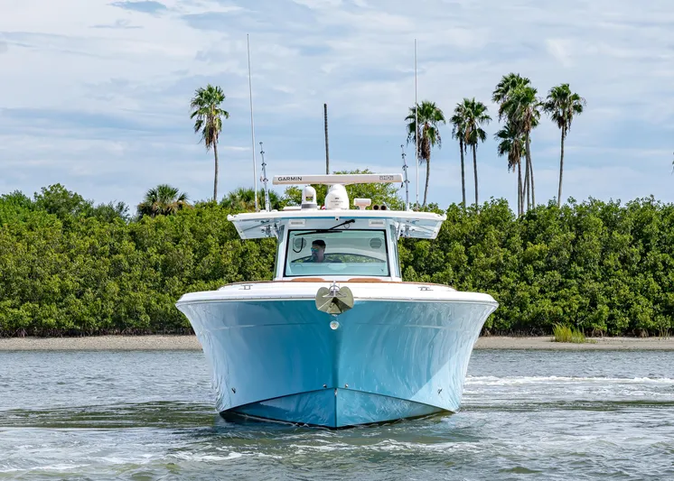  Yacht Photos Pics 2020 HCB Suenos boat cruising on water with palm trees in background.