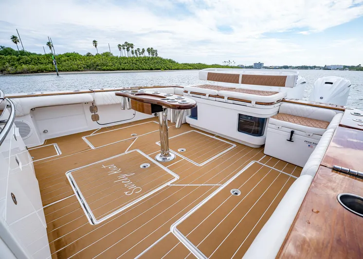  Yacht Photos Pics 2020 HCB Suenos boat deck with seating and table, on a scenic waterway.