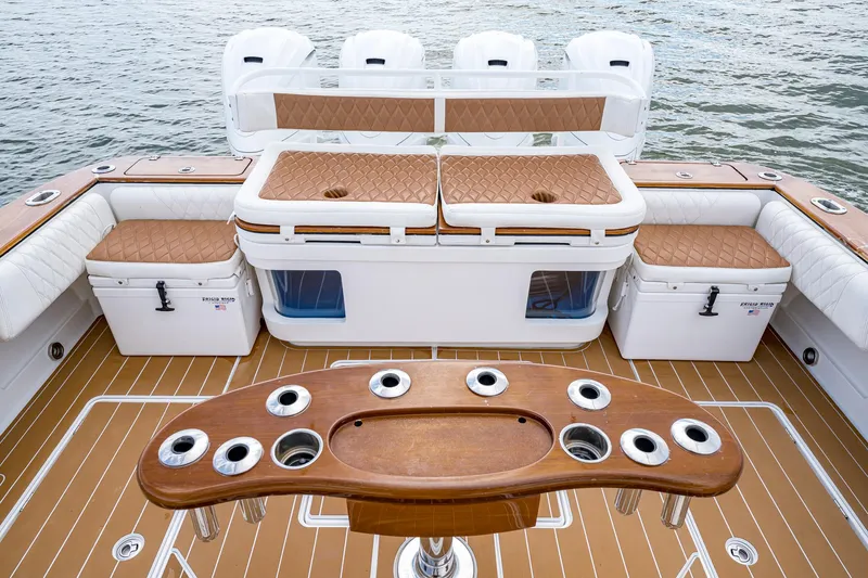  Yacht Photos Pics 2020 HCB Suenos boat deck with seating, rod holders, and storage, on water.