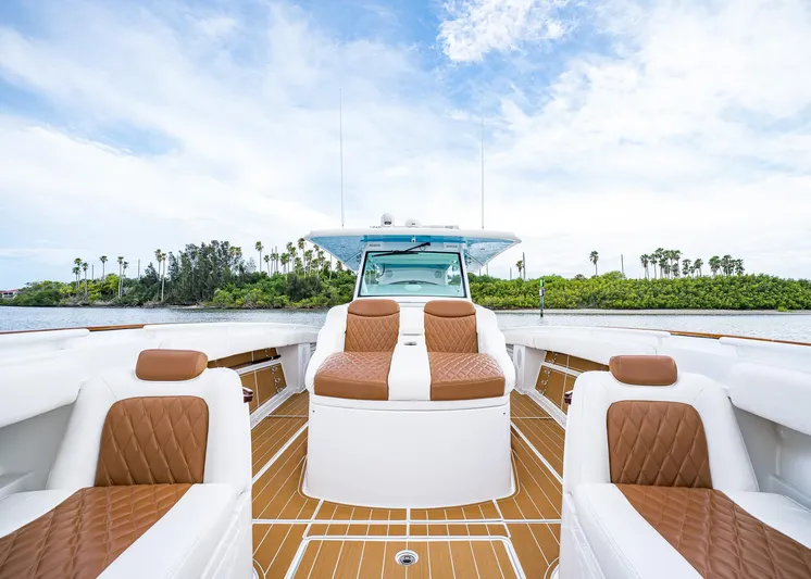  Yacht Photos Pics 2020 HCB Suenos boat interior with brown leather seating and wooden deck, under a clear sky.