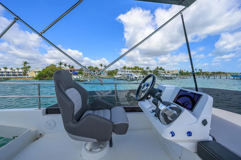 Don't Wake Me Yacht Photos Pics Flybridge of 2022 Jeanneau NC Weekender 1095, featuring helm and scenic ocean view.