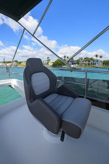 Don't Wake Me Yacht Photos Pics 2022 Jeanneau NC Weekender 1095 Fly captain's chair on deck, overlooking serene waters.