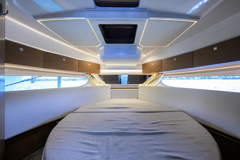 Don't Wake Me Yacht Photos Pics Interior cabin of 2022 Jeanneau NC Weekender 1095 Fly, featuring modern design and comfortable bedding.