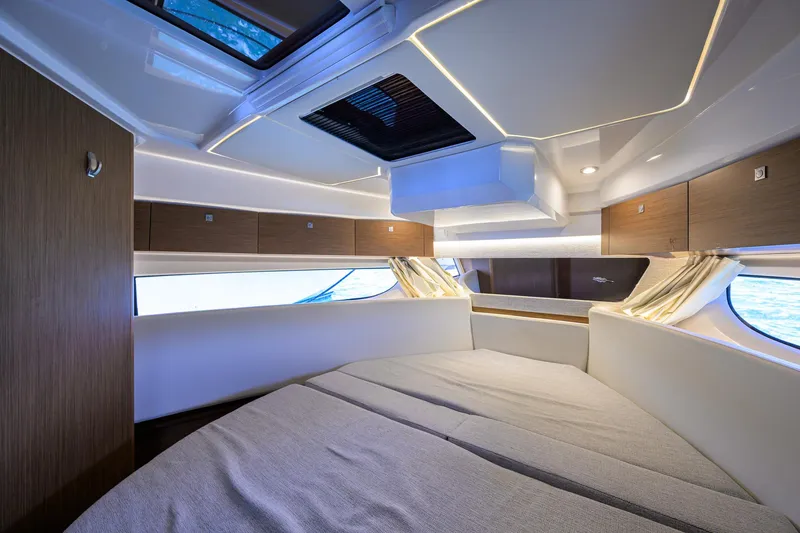 Don't Wake Me Yacht Photos Pics 2022 Jeanneau NC Weekender 1095 Fly cabin with modern interior and large windows.