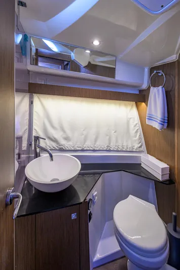 Don't Wake Me Yacht Photos Pics 2022 Jeanneau NC Weekender 1095 Fly bathroom with modern sink and toilet.