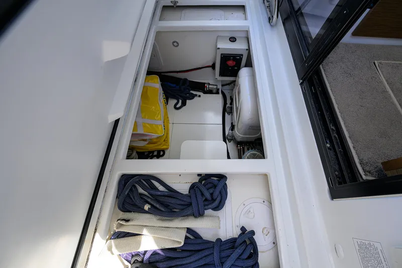 Don't Wake Me Yacht Photos Pics Storage compartment on a 2022 Jeanneau NC Weekender 1095 Fly with ropes and safety gear.