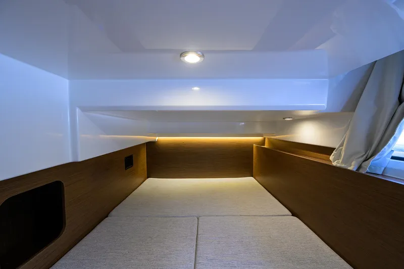 Don't Wake Me Yacht Photos Pics Interior cabin of 2022 Jeanneau NC Weekender 1095 Fly, featuring modern lighting and wood accents.