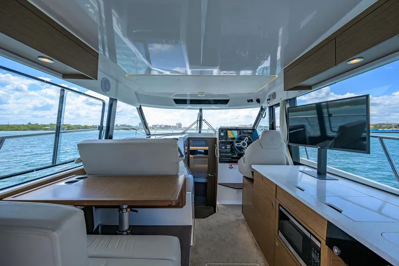 Don't Wake Me Yacht Photos Pics Interior of 2022 Jeanneau NC Weekender 1095 Fly, featuring modern helm and seating area.