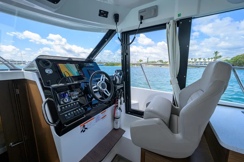 Don't Wake Me Yacht Photos Pics 2022 Jeanneau NC Weekender 1095 Fly cockpit with modern controls and ocean view.