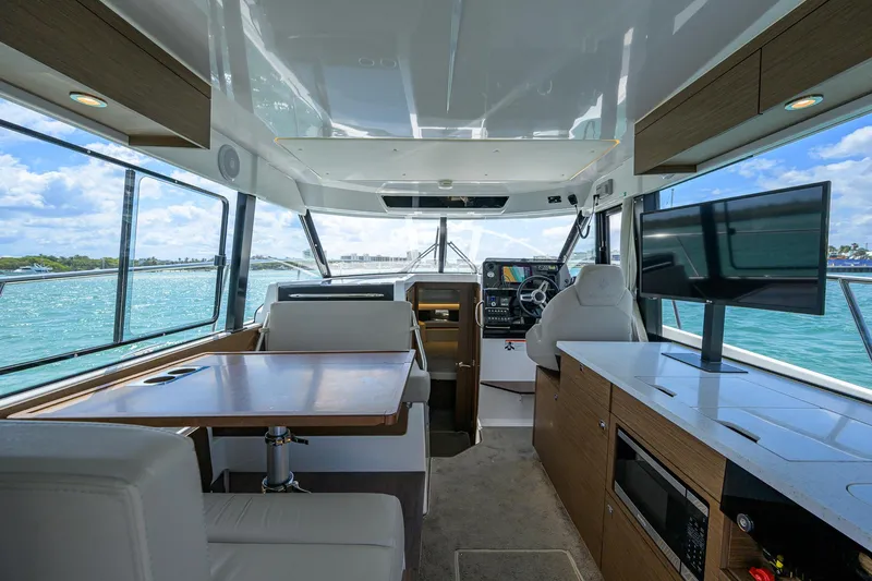 Don't Wake Me Yacht Photos Pics Interior of 2022 Jeanneau NC Weekender 1095 Fly, featuring modern seating and navigation area.