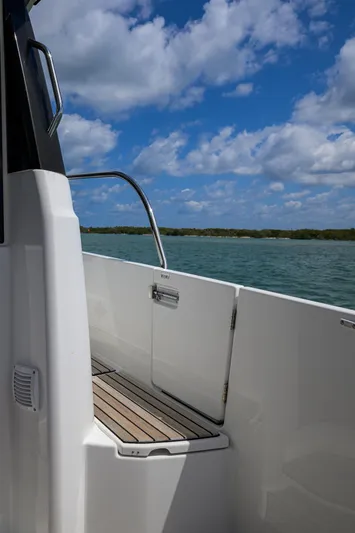 Don't Wake Me Yacht Photos Pics 2022 Jeanneau NC Weekender 1095 Fly boat deck with scenic water view.